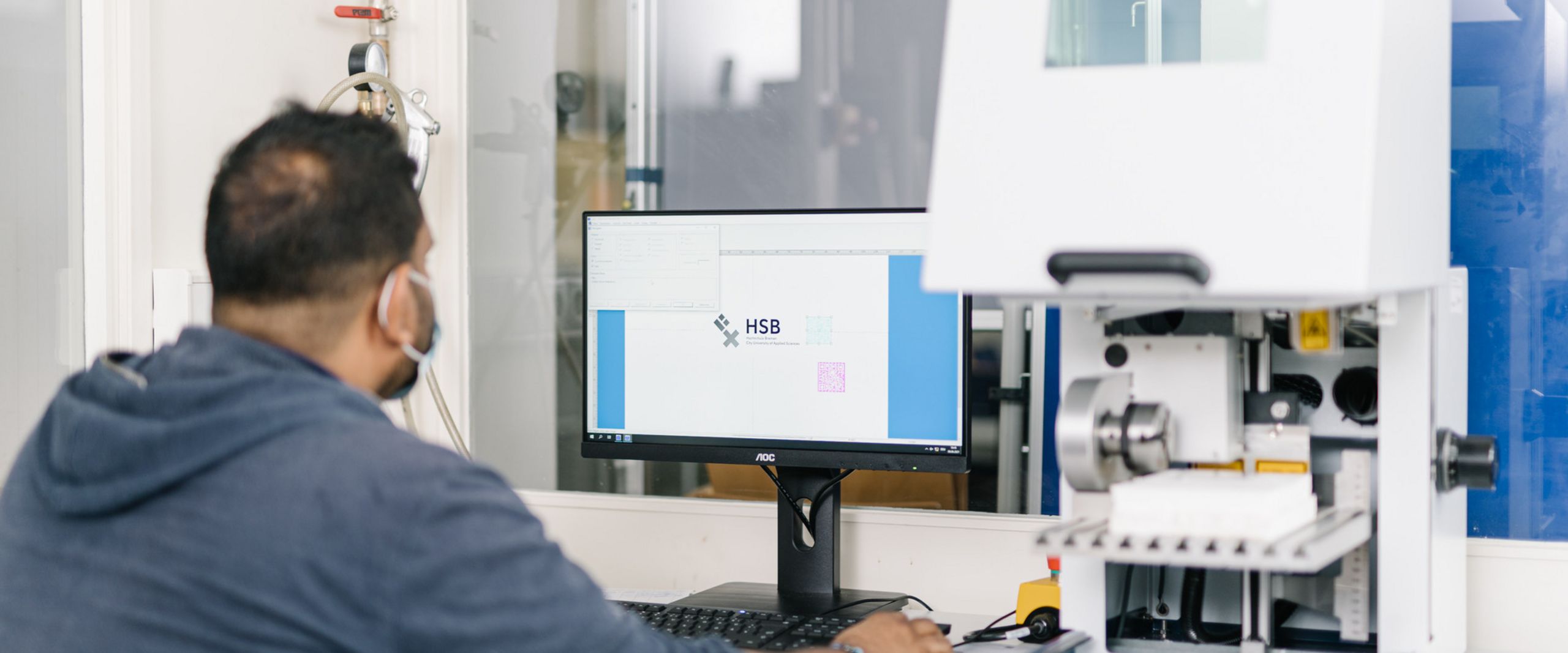 Lasergravur Ein Studierender bei der Arbeit an einer Lasergravurmaschine