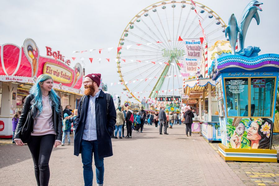 Osterwiese Zwei Studierende schlendern über die Osterwiesenkirmes.